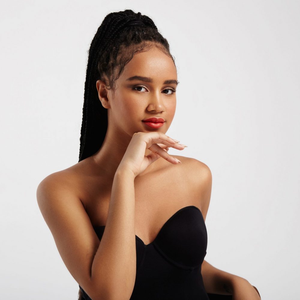 pretty black woman's portrait wears braids in pony tail